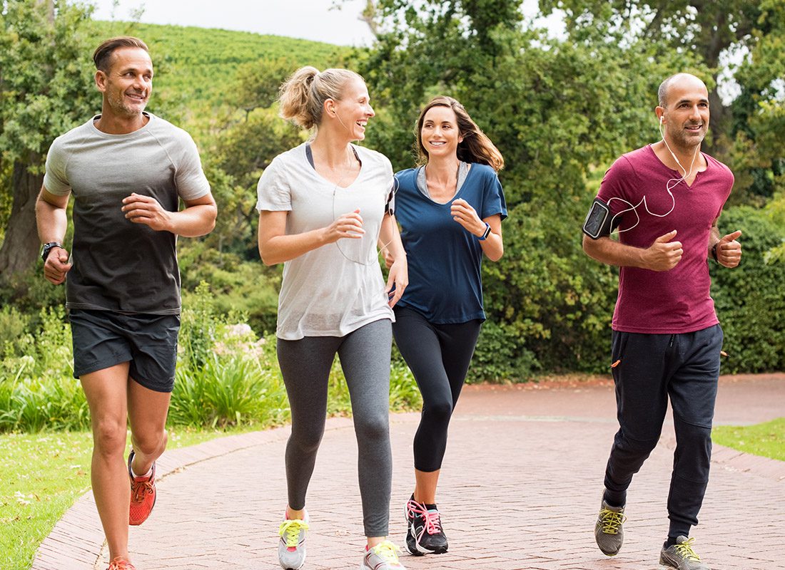Employee Benefits - Group of People Jogging Together at a Park on a Sunny Day