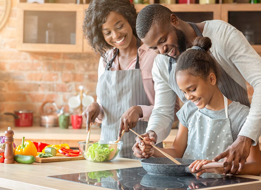 Personal Insurance - Happy Family and Daughter Preparing Salad Together at Home